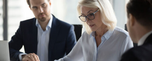 Persons in office reviewing expenses
